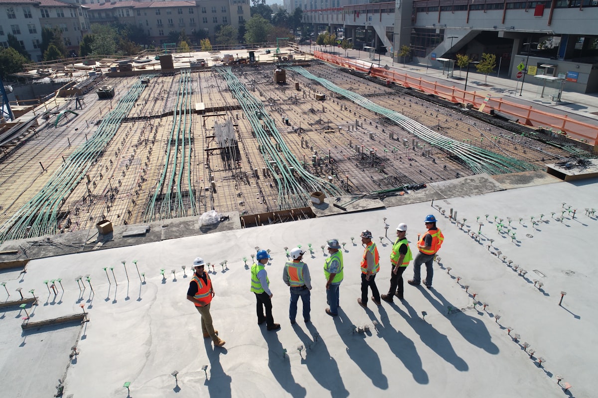 A site team in high visibility clothing standing on a concrete slab